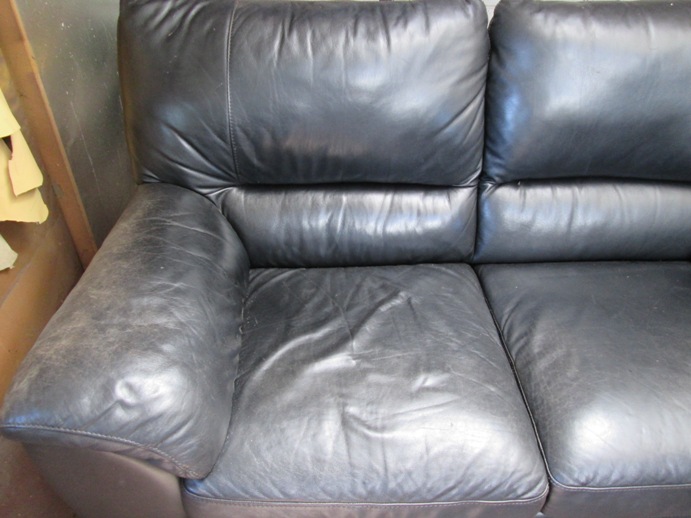 Faded black leather couch before starting