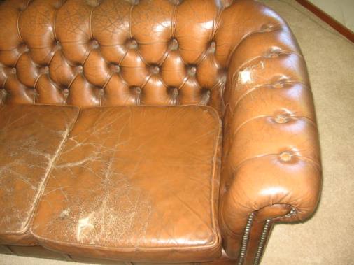 worn leather couch showing cracks