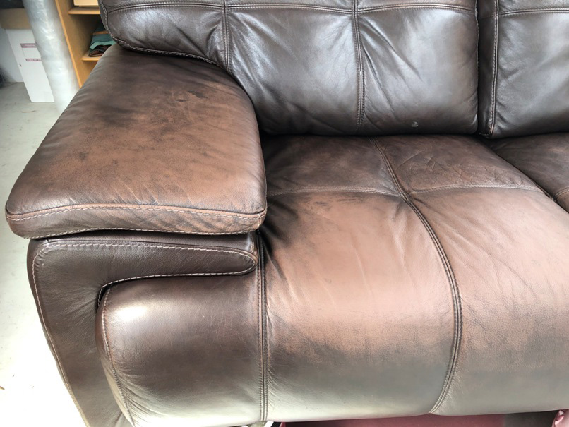 Damaged brown leather couch